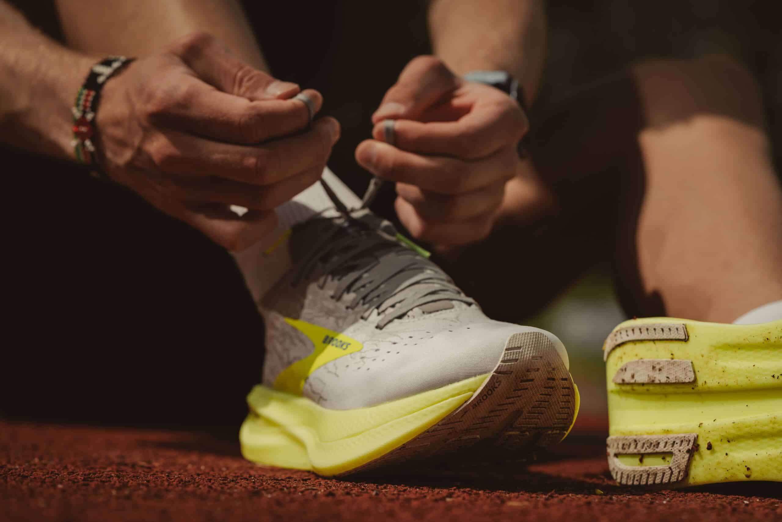 Ein Mensch bindet sich die Laufschuhe zu vor dem Sprint